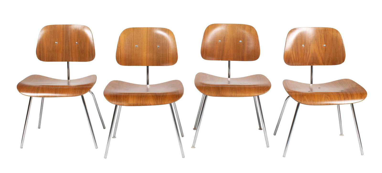SET OF FOUR CHARLES EAMES FOR HERMAN MILLER DCM CHAIRS: SET OF FOUR CHARLES EAMES FOR HERMAN MILLER DCM CHAIRS American (Zeeland, Michigan), circa 1970s, laminated wood and chromed steel. With metal tags and labels to underside of seats. Each: 30 1/4 x 18