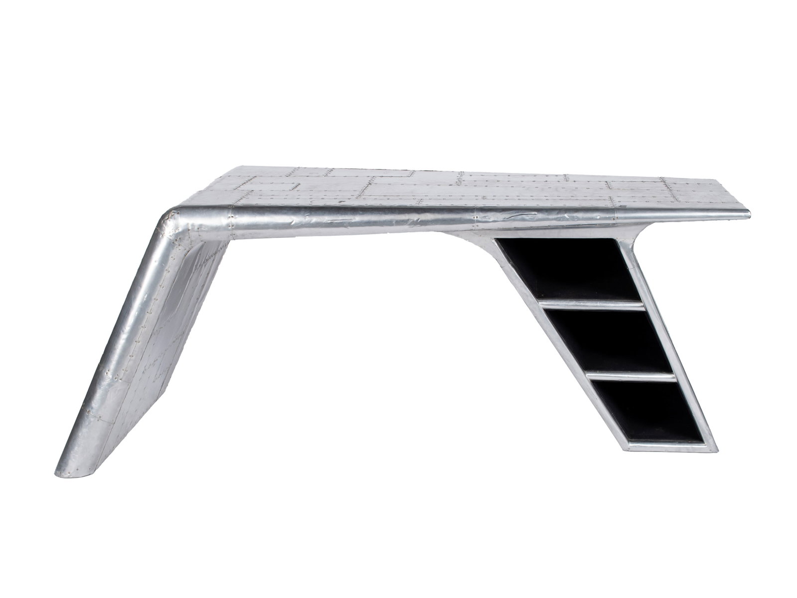 TIMOTHY OULTON AVIATOR DESK: TIMOTHY OULTON AVIATOR DESK 20th century. Pieced and hammered aluminum desk in the form of a Valkyrie airplane wing, with three open shelves in the leg. 30 x 34 x 77 in. (76.2 x 86.4 x 195.6 cm.),