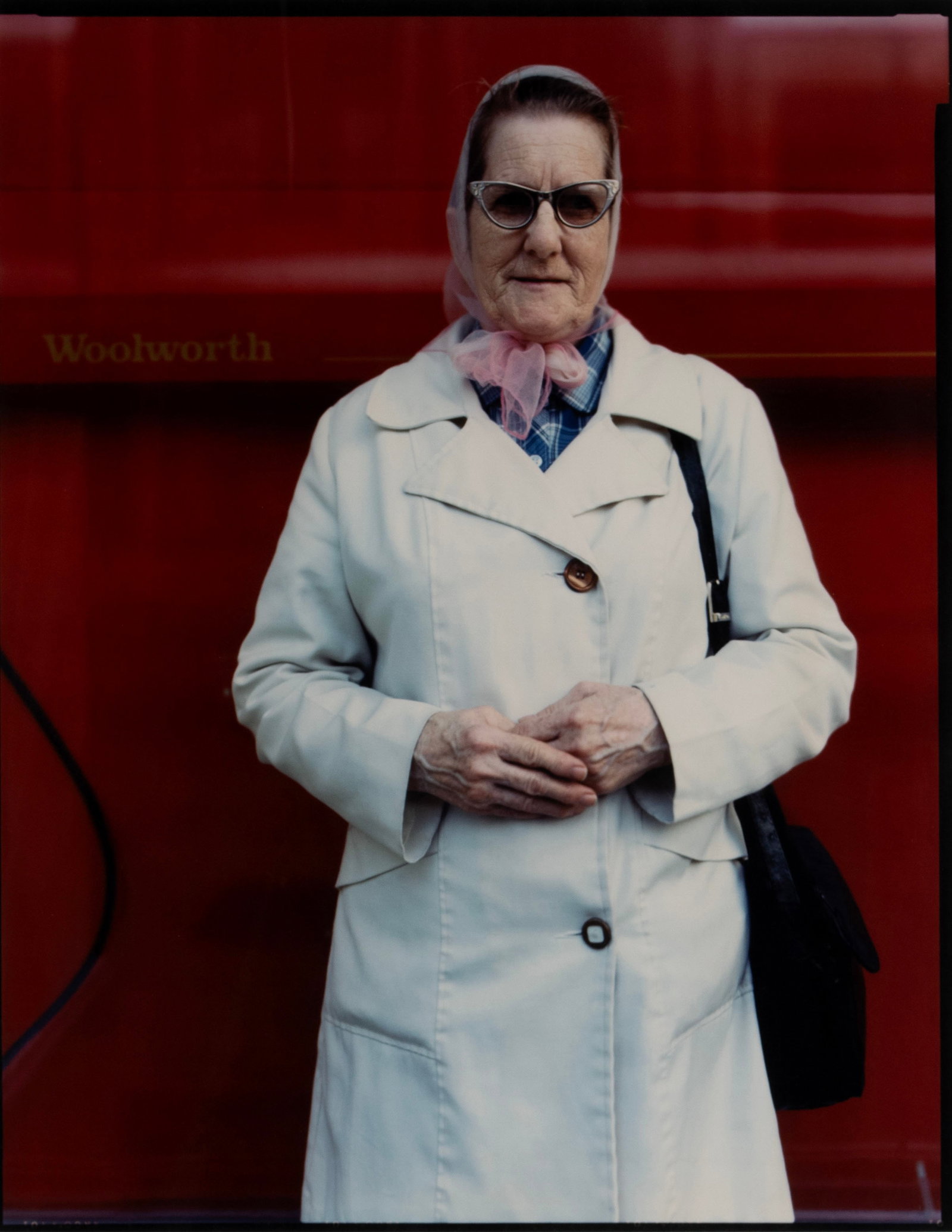 BRUCE WRIGHTON (AMERICAN, 1950-1988): Bruce Wrighton American, 1950-1988 Woman in White Raincoat, 1988 Chromogenic print Estate stamp on verso, #1/20, 2008. Portrait from 'Binghamton Street People' series, matted and framed with Laurence 