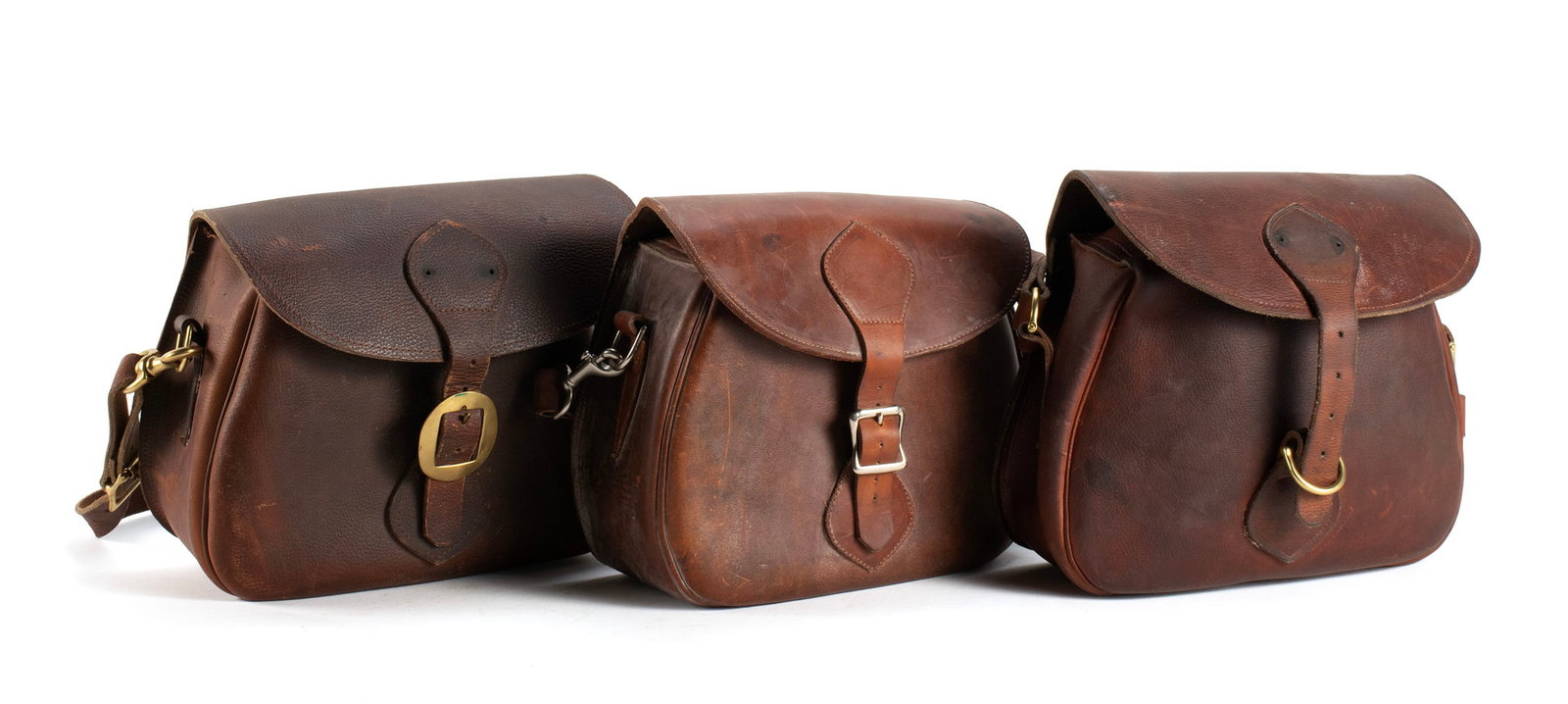 THREE GOKEY LEATHER GAME HUNTING SHOULDER BAGS: THREE GOKEY LEATHER GAME HUNTING SHOULDER BAGS American, 20th century, with "GOKEY" labels. Plain leather pouches with shoulder straps and brass hardware. 9 x 11 x 5 in. (22.9 x 27.9 x 12.7 cm.)