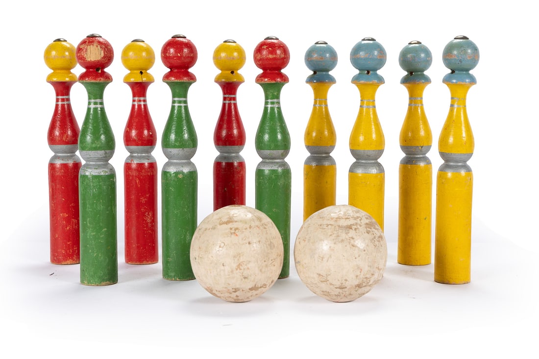 VINTAGE SKITTLES GAME: VINTAGE SKITTLES GAME Ten (10) painted wooden pins and two (2) balls. Pin: 9 3/4 x 1 1/2 in. (24.8 x 3.8 cm.)
