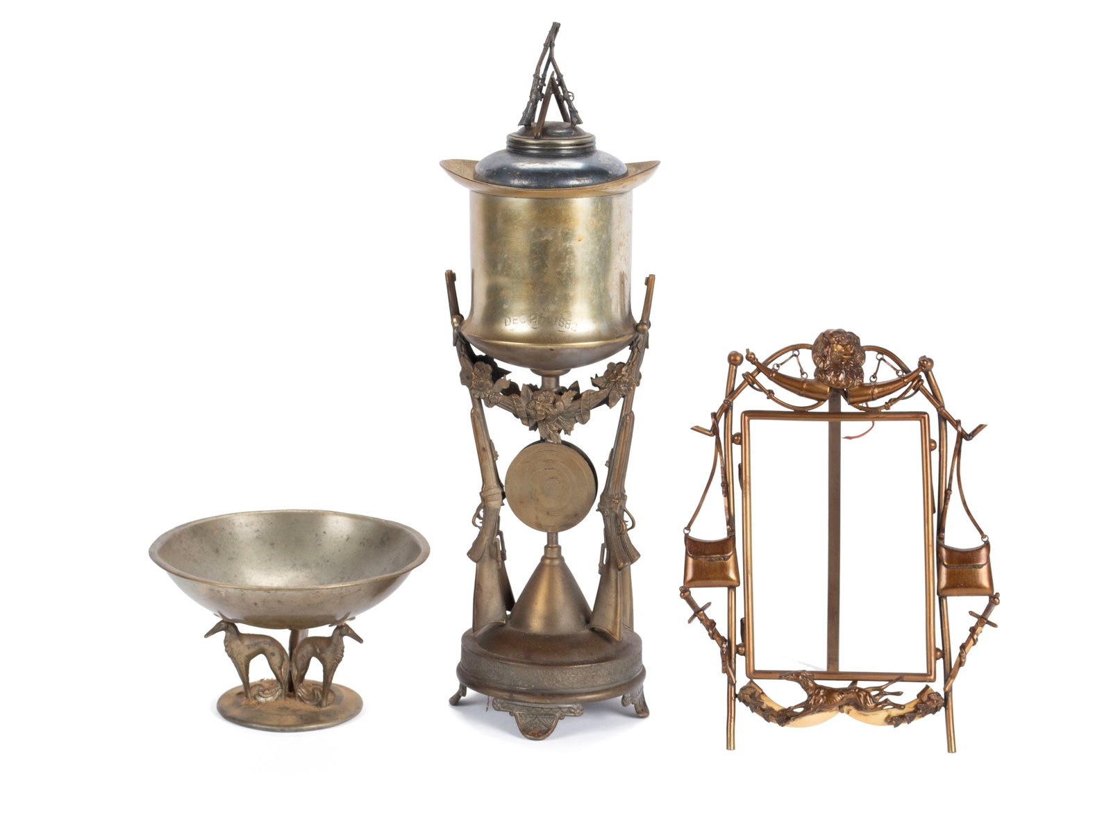 THREE CANINE AND SHOOTING RELATED TROPHYS INCLUDING PAIRPOINT: THREE CANINE AND SHOOTING RELATED TROPHYS INCLUDING PAIRPOINT American, 19th/20th century. One a Pairpoint lidded cup on stand, or shell holder, with rifle supports and rifle finial, dated Dec. 25, 18