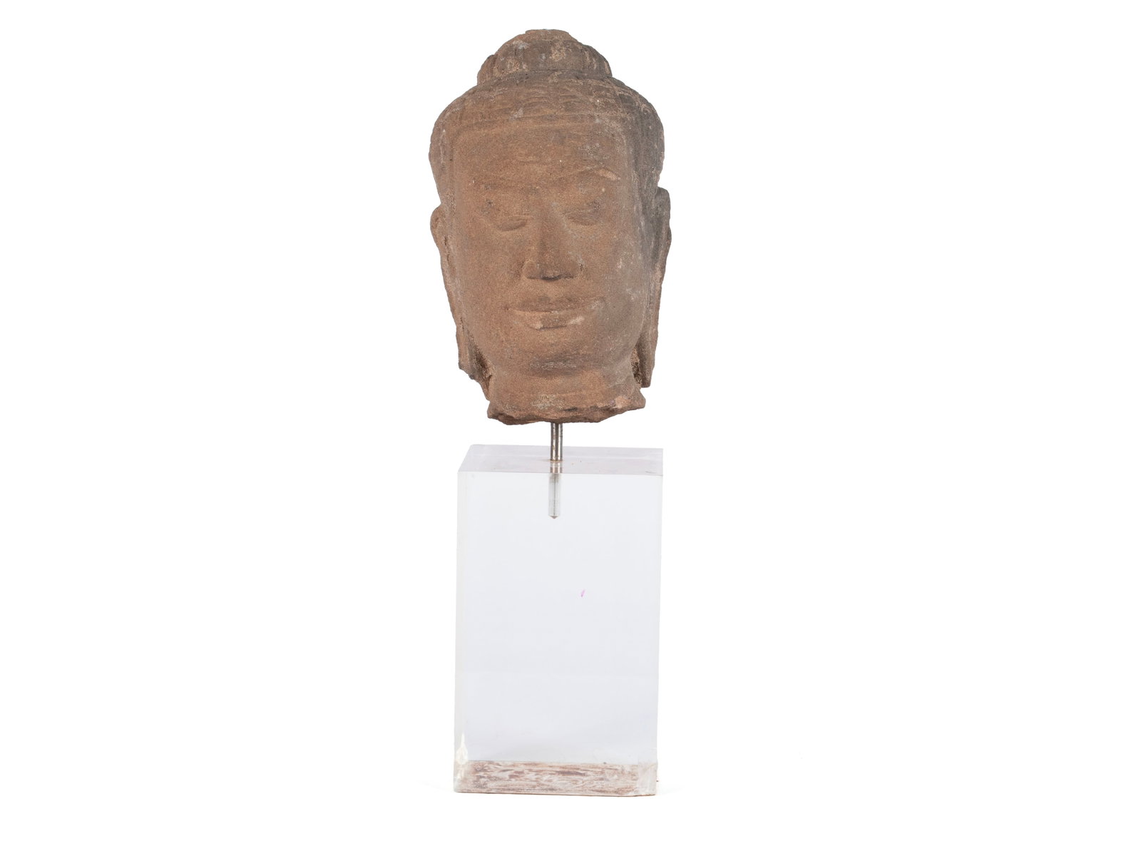 CARVED STONE BUDDHA HEAD: CARVED STONE BUDDHA HEAD Southwest Asian (Cambodian), likely 14th century or older, sandstone. Detailed bust of a Khmer-style Buddha head, on a plexiglass stand. Carving: 8 in. (20.3 cm.), Overall: