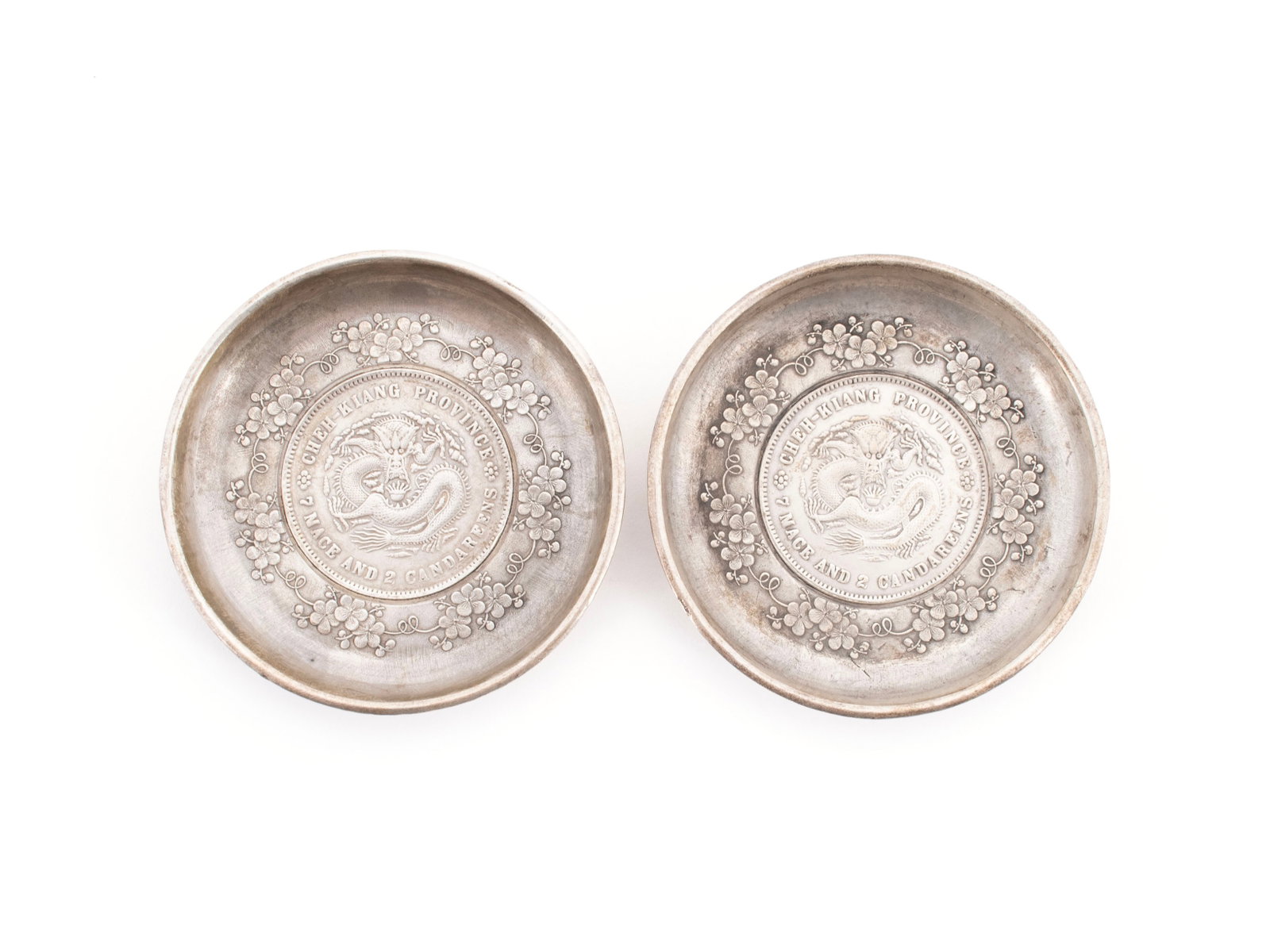 PAIR OF GUANGXU CHEH-KIANG PROVINCE 7 MACE AND 2 CANDAREENS COINS: PAIR OF GUANGXU CHEH-KIANG PROVINCE 7 MACE AND 2 CANDAREENS COINS Each coin set into a collectible silver dish; coin with five clawed dragon hovering above a flaming pearl to the face and characters