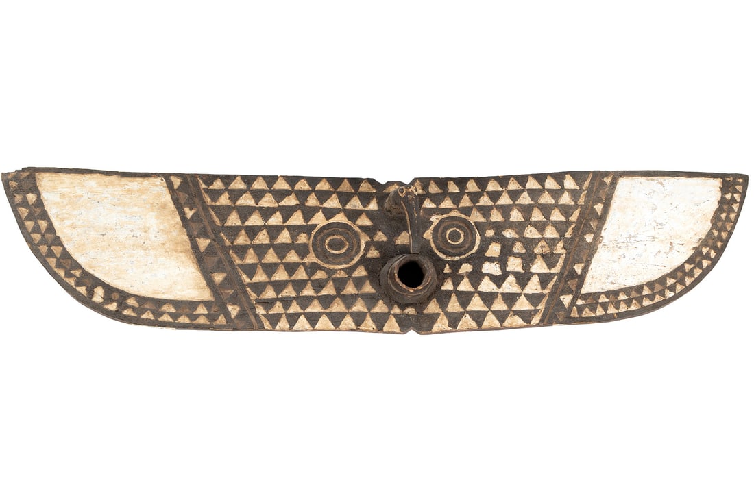 BWA PLANK BUTTERFLY MASK: BWA PLANK BUTTERFLY MASK Burkina Faso, North African, mid-20th century. Carved in geometric forms centering a head and hole flanked by circular eyes, colored black and white, bottom side carved and pa