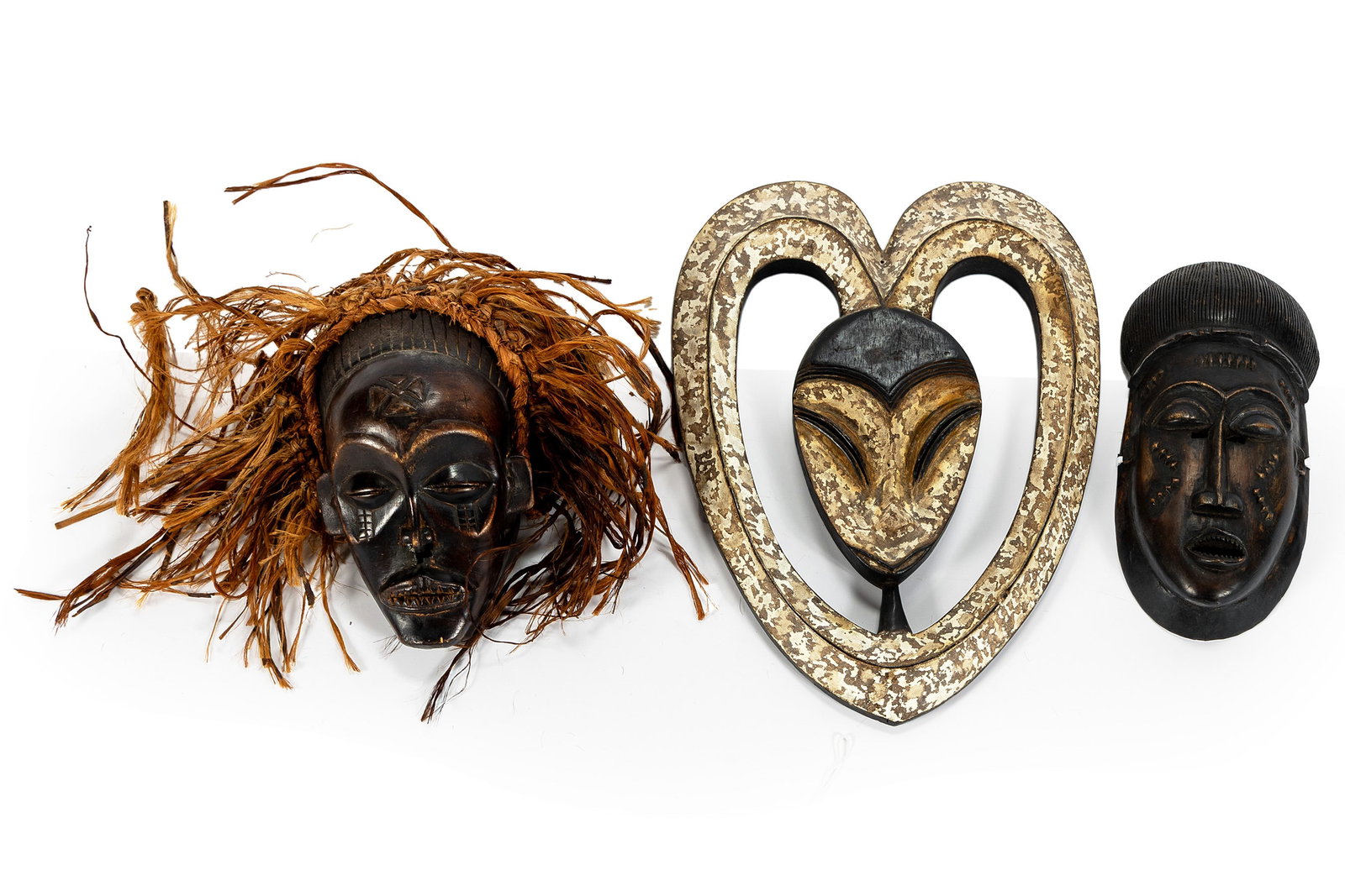 THREE CARVED WOODEN AFRICAN MASKS (1 of 5)