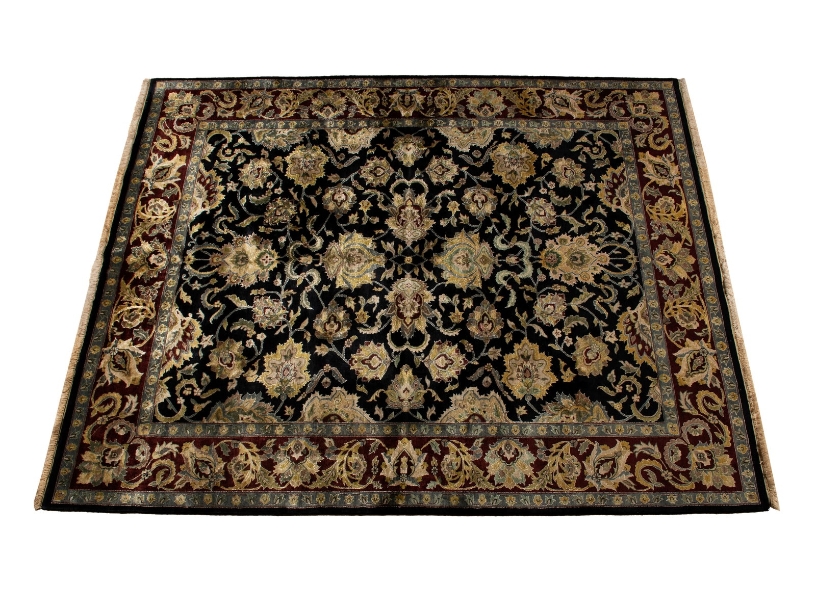 INDIAN ROOM RUG: INDIAN ROOM RUG India, 20th century. Scrolling vines filled with golden flowers and foliage against the black ground, red border with grey guard borders. 9 ft. 11 in. x 7 ft. 9 in. (302.3 x 236.2 cm.)