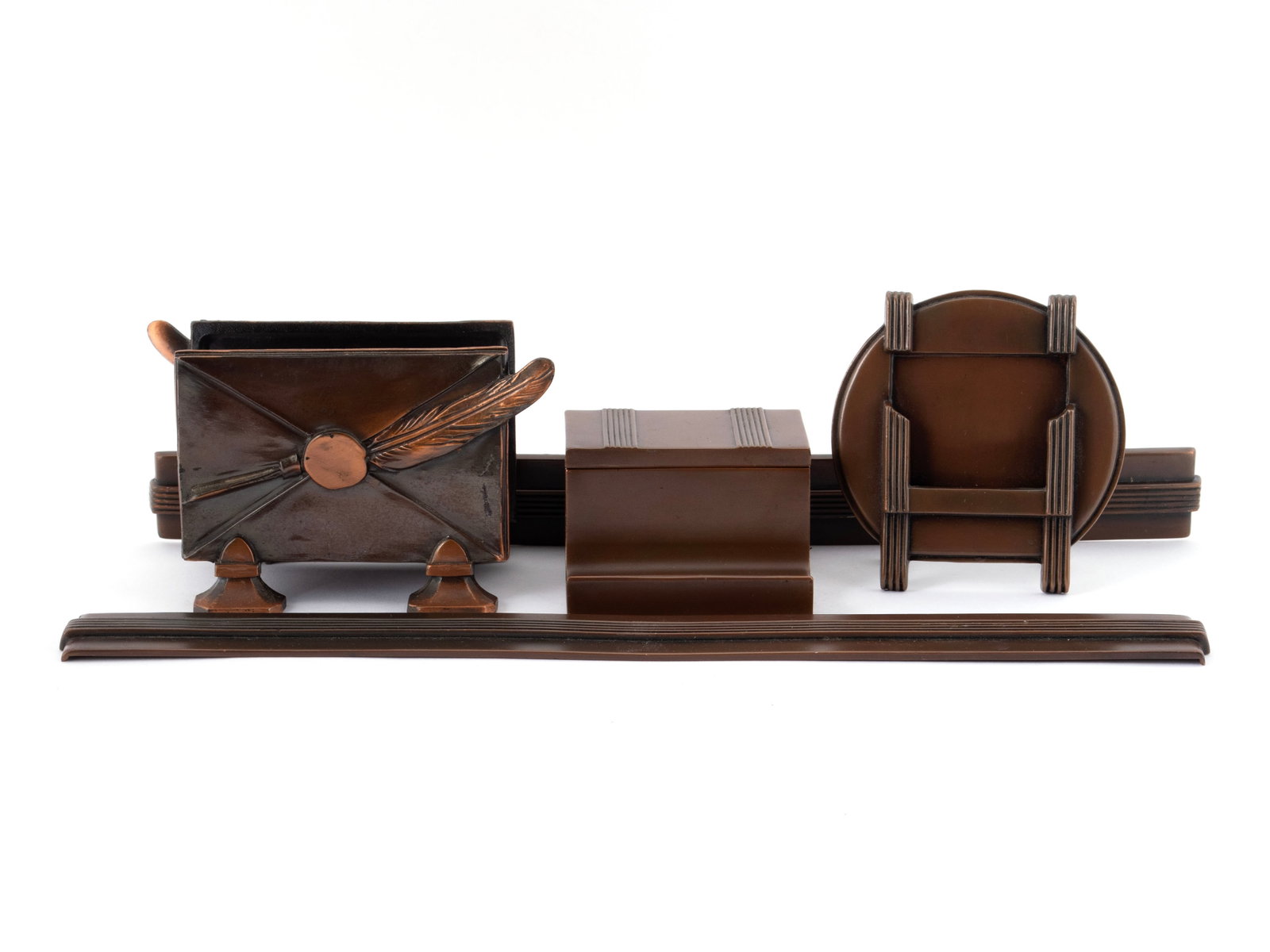 KRONHEIM & OLDENBUSCH ARTS & CRAFTS DESK SET: KRONHEIM & OLDENBUSCH ARTS & CRAFTS DESK SET American, circa 1920s, copper. Inkwell in stand, letter holder, calendar stand, and two-part blotter ends. Blotter ends: 14 1/2 in. (36.8 cm.)