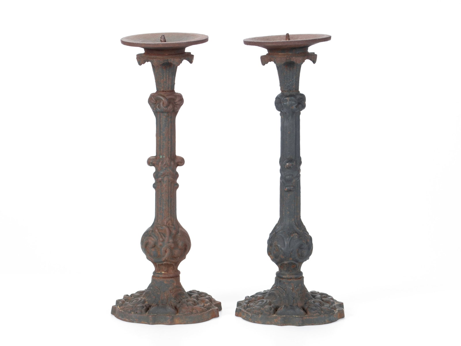 PAIR OF CAST IRON PRICKET STICKS: PAIR OF CAST IRON PRICKET STICKS Continental, 20th century. Pair of candlesticks with foliate and scrolled designs throughout. 15 in. (38.1 cm.)