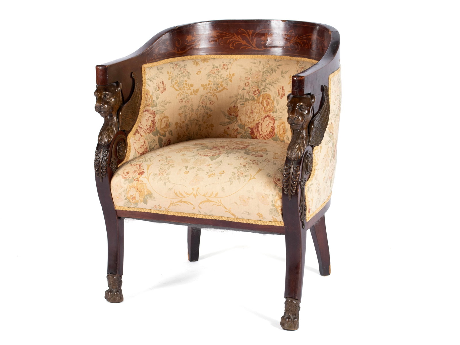 EMPIRE BARREL BACK CHAIR: EMPIRE BARREL BACK CHAIR Continental, 19th century, mahogany veneer. Wrap-around barrel back inlaid with scrolling foliate designs, the large bronze arm supports in the form of griffins, on sabre