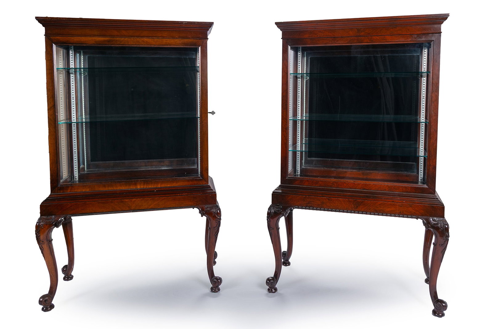 PAIR OF DISPLAY CABINETS BY THE COLONIAL MFG COMPANY: PAIR OF DISPLAY CABINETS BY THE COLONIAL MFG COMPANY American, early 20th century, mahogany. Rectangular displays glazed on three sides with mirrored back panels, the front panel sliding for access,
