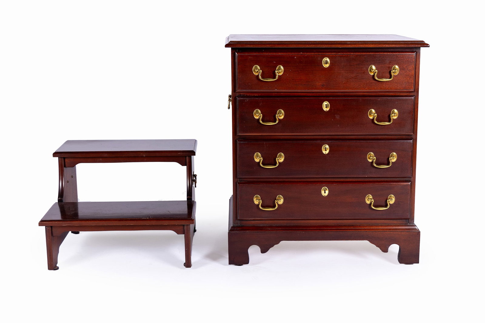 BACHELORS CHEST AND STAIRS: BACHELORS CHEST AND STAIRS American, 20th century. A White Furniture Co. four drawer Georgian style bachelor's chest, labeled to drawer interior, and mahogany bed steps. Chest: 30 1/2 x 26 x 16 1/4
