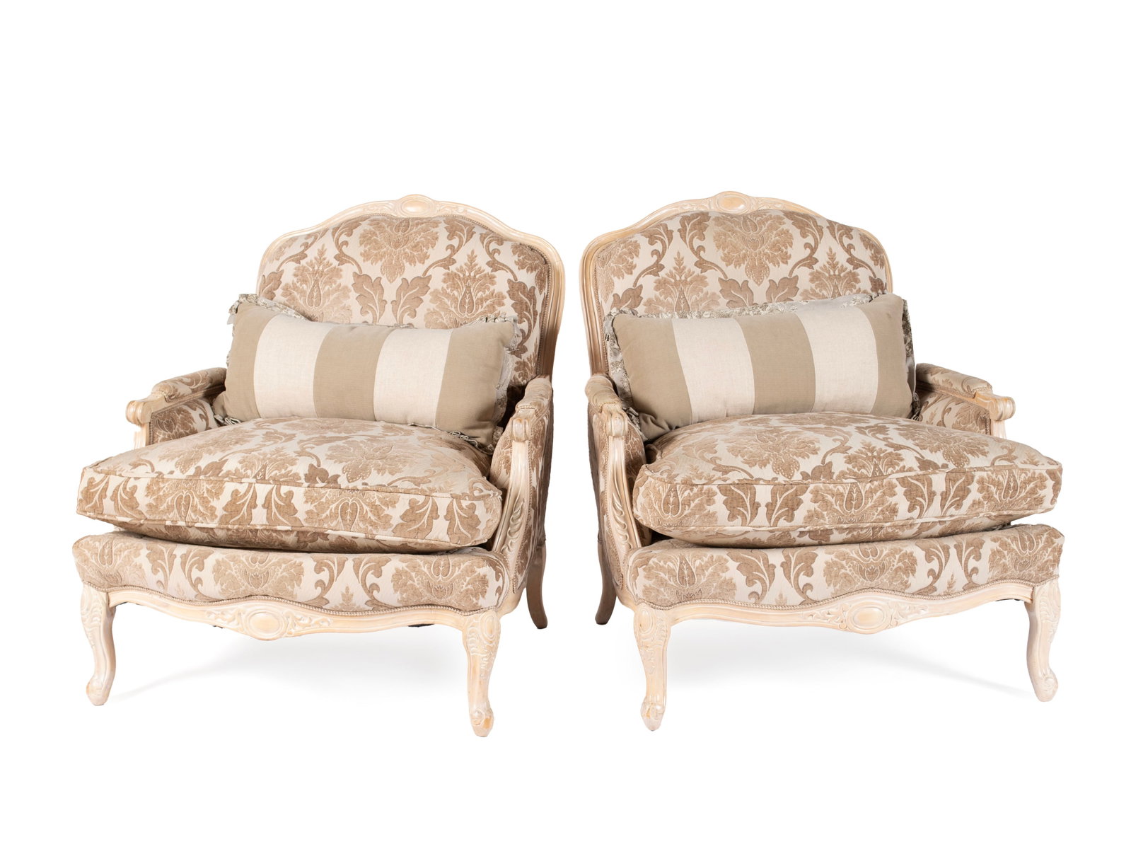 PAIR OF UPHOLSTERED BERGERES: PAIR OF UPHOLSTERED BERGERES Late 20th/early 21st century. Provincial style wooden frames, overstuffed upholstery with accent pillows. 36 x 33 x 39 in. (91.4 x 83.8 x 99.1 cm.)
