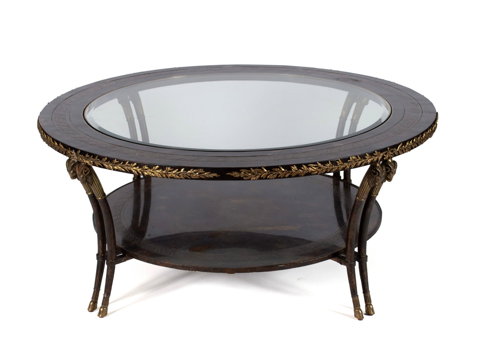 CENTURY EMPIRE STYLE COCKTAIL TABLE: CENTURY EMPIRE STYLE COCKTAIL TABLE American, 20th century. Circular with inset glass center on curved ram's head legs joined by a lower shelf, gold finish metal highlights throughout. 21 1/2 x 50