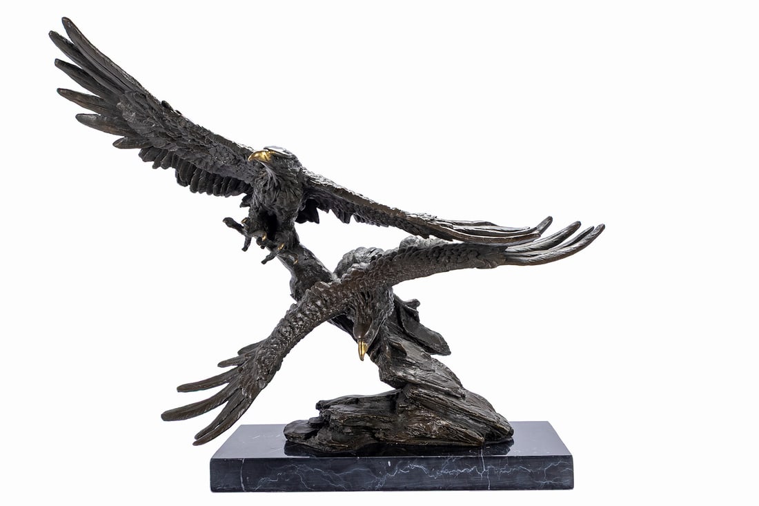 DOUBLE FLYING EAGLES BRONZE: DOUBLE FLYING EAGLES BRONZE Late 20th century, unsigned. Two eagles in flight over a rocky peak, mounted on a black marble base. 15 x 4 3/4 x 18 1/2 in. (38.1 x 12.1 x 47 cm.)