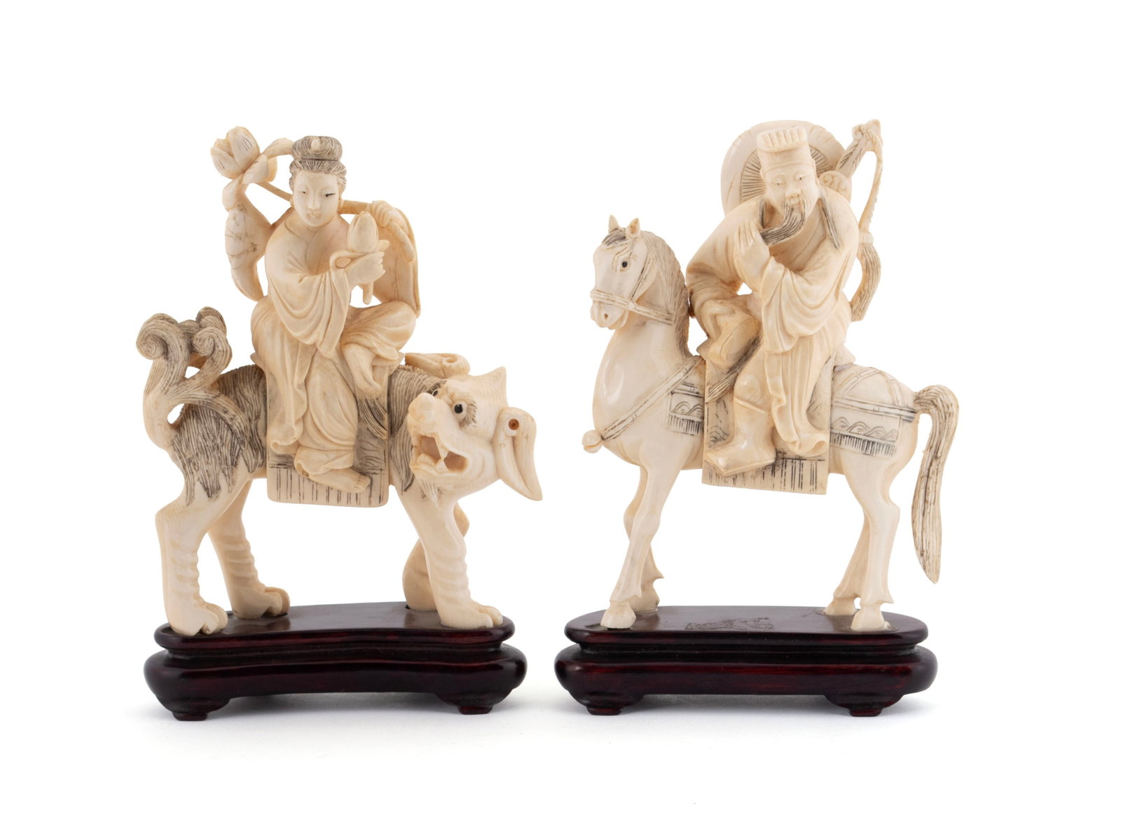 CARVED EMPEROR AND EMPRESS FIGURES: CARVED EMPEROR AND EMPRESS FIGURES Chinese, early 20th century. Emperor on horseback and Empress in the manner of Guanyin on Qilin, on wooden stands. 7 x 1 1/2 x 4 1/2 in. (17.8 x 3.8 x 11.4 cm.)