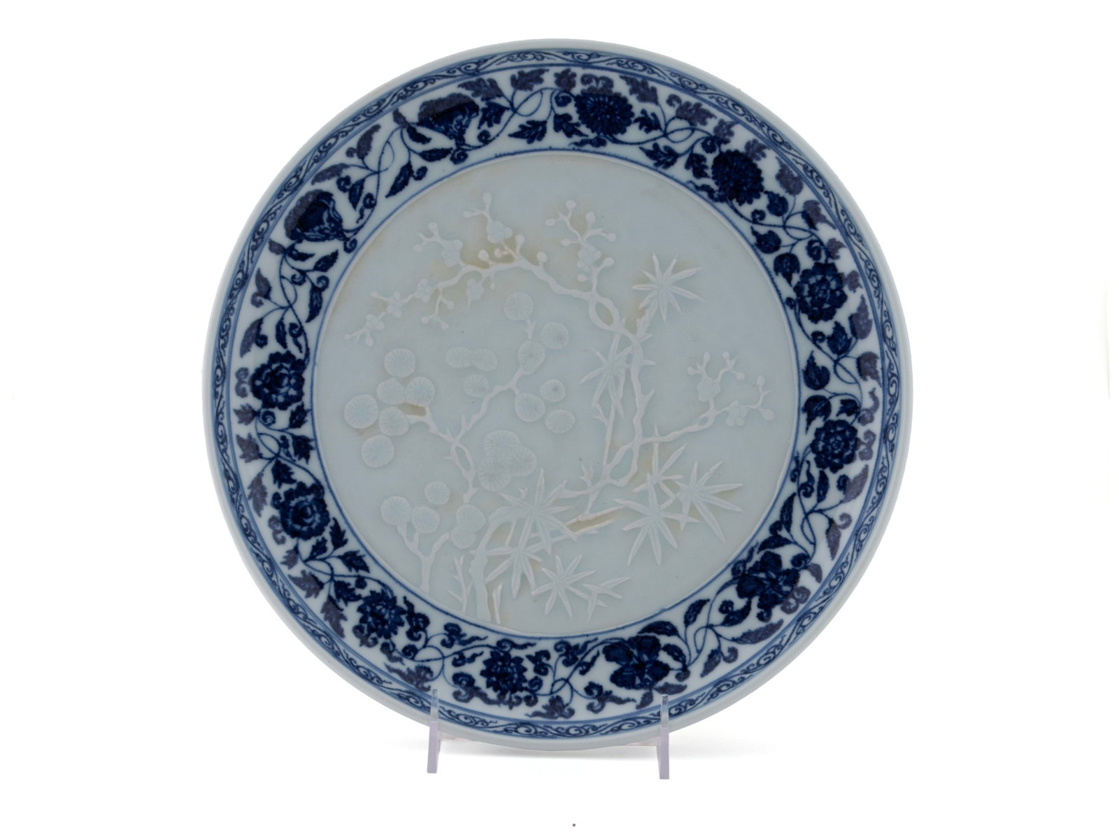 CHINESE BLUE AND WHITE PORCELAIN CHARGER: CHINESE BLUE AND WHITE PORCELAIN CHARGER 20th century. Ming style charger having slip plum blossom and bamboo decoration to interior surrounded by blue foliate scroll, six-character Xuande in a line m