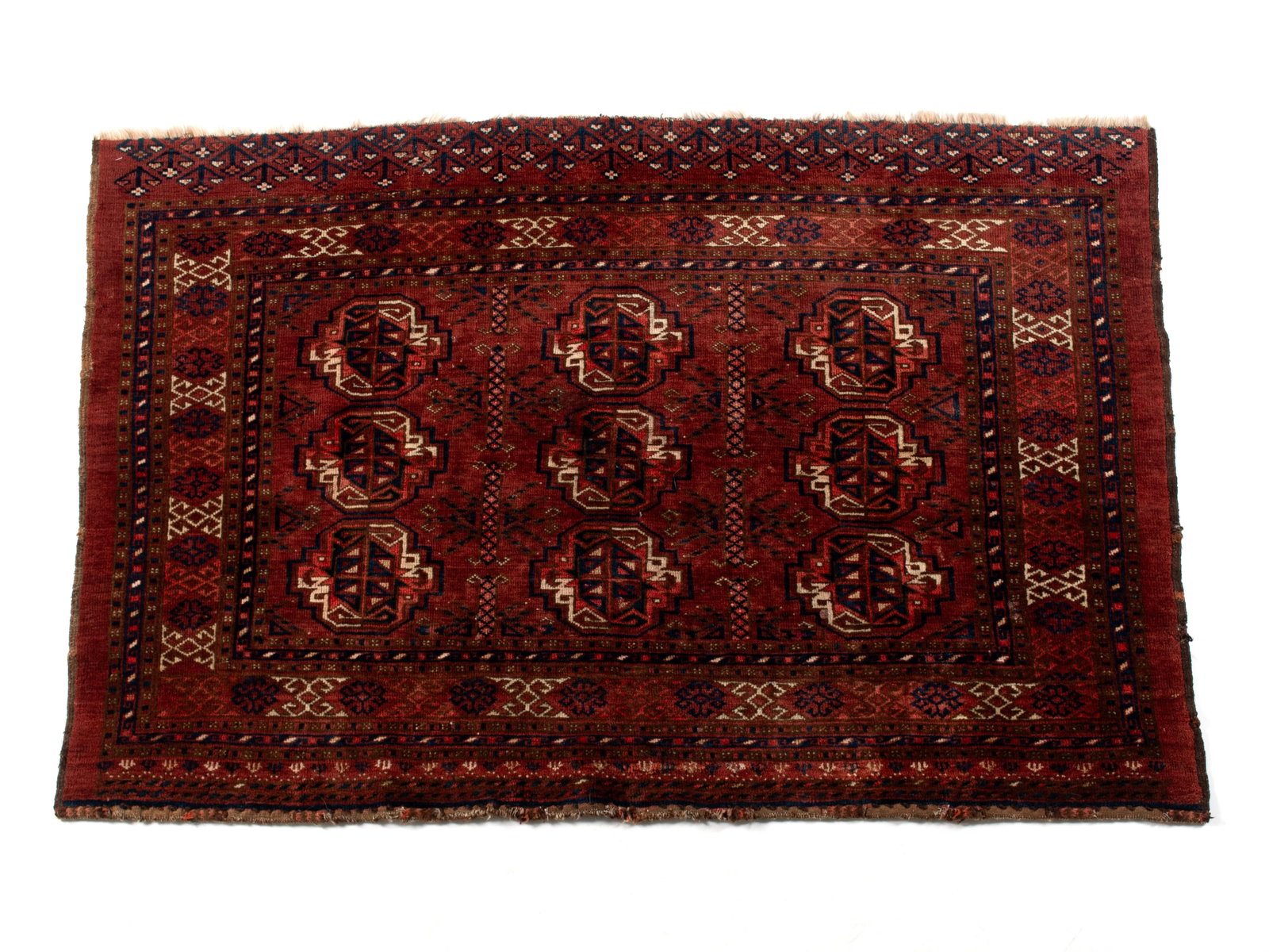 BOKHARA AREA RUG: BOKHARA AREA RUG Turkish, early 20th century, likely a large bag face. Three rows of boteh medallions with multiple borders, shades of navy and ivory to the mostly red carpet. 3 ft. x 4 ft. 5 in.