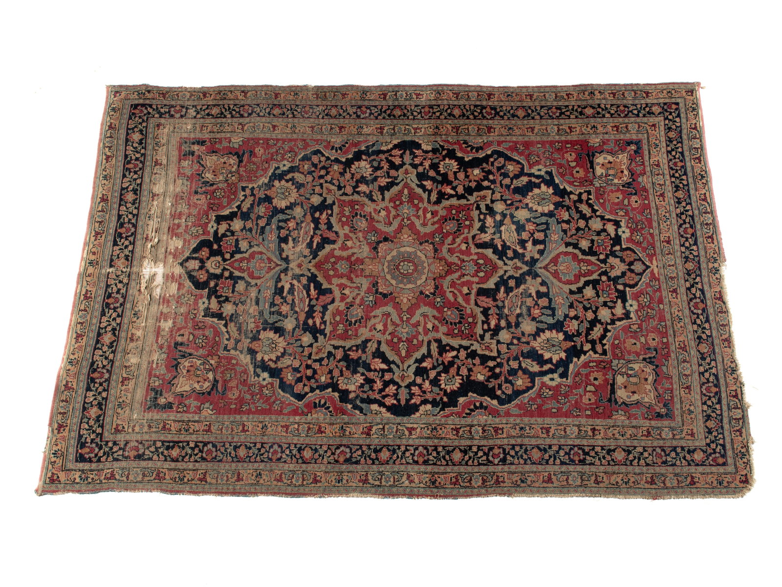 FERAGHAN AREA RUG: FERAGHAN AREA RUG Persian, early 20th century. Red foliate medallion with matching corners, around the floral decorated navy field, navy border with multiple guard borders. Shows wear. 6 ft. 2 in. x