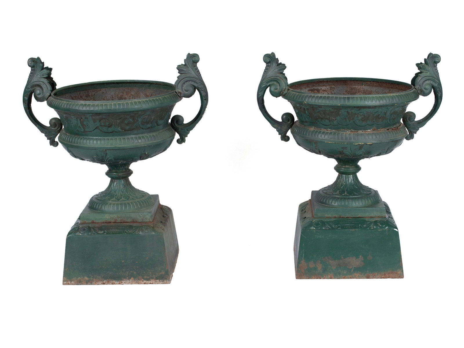 PAIR OF CLASSICAL STYLE CAST IRON GARDEN URNS BY KRAMER BROS.: PAIR OF CLASSICAL STYLE CAST IRON GARDEN URNS BY KRAMER BROS. American, 19th century. Circular urns with scrolling foliate handles, on a circular foliate pedestal base, all resting on the square base