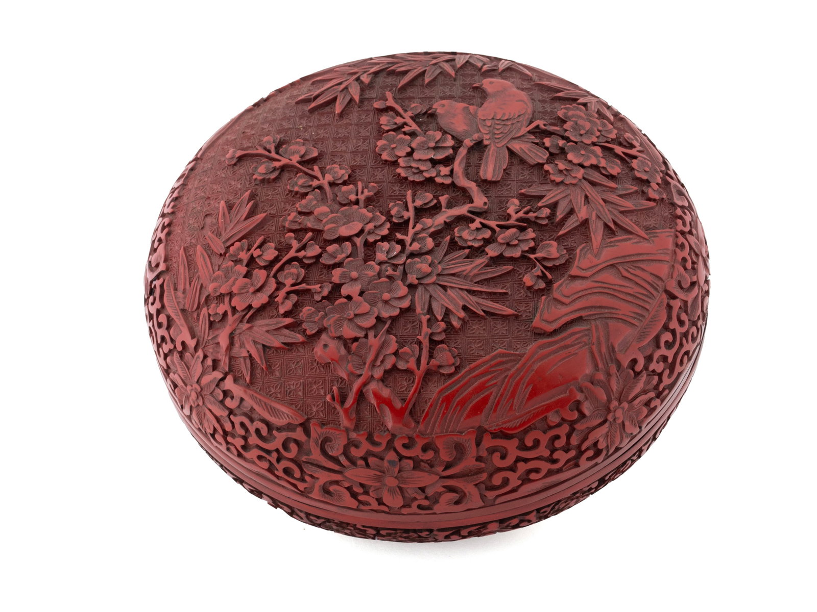 CHINESE QING CINNABAR LACQUER CARVED COVERED BOX: CHINESE QING CINNABAR LACQUER CARVED COVERED BOX 19th Century, round lidded box having Magpie and Plum tree decoration, illegible four-character mark underfoot. 4 1/2 x 10 1/2 in. (11.4 x 26.7 cm.)