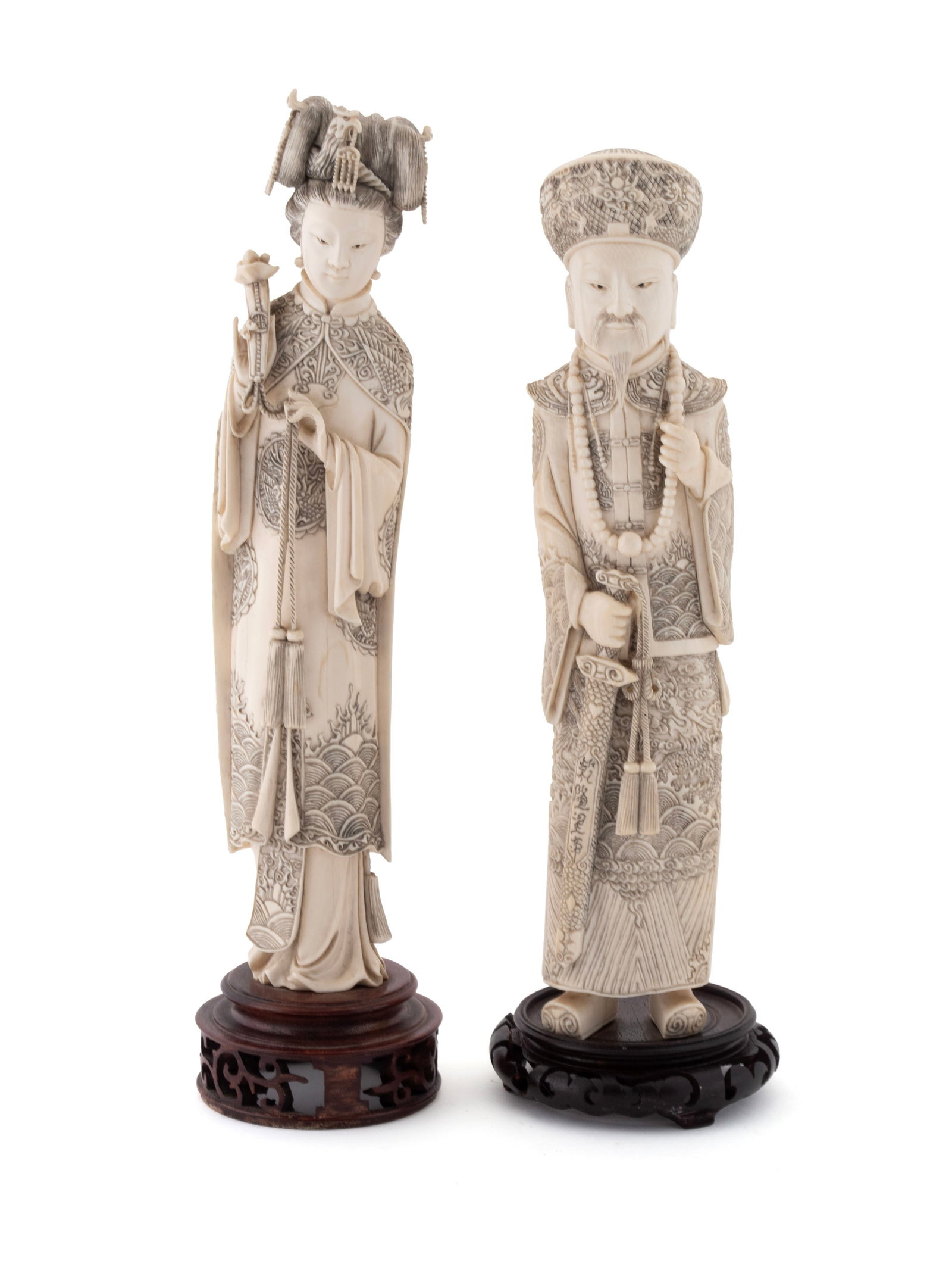 PAIR OF CHINESE CARVED EMPEROR AND EMPRESS FIGURES: PAIR OF CHINESE CARVED EMPEROR AND EMPRESS FIGURES 19th Century, Emperor in dragon longpao, the Empress in Phoenix longpao, Qianlong mark to scabbard. 13 x 3 1/2 in. (33 x 8.9 cm.)