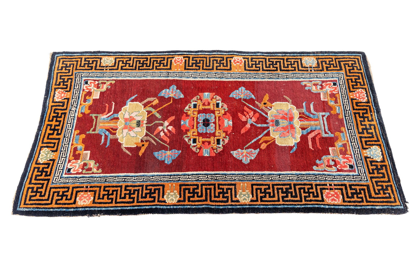 PEKING THROW RUG: PEKING THROW RUG Chinese, 19th century. Colorful lotus medallions decorate the deep red field, bronze border decorated with dark geometric designs with an occasional rose bud, showing a single Greek k