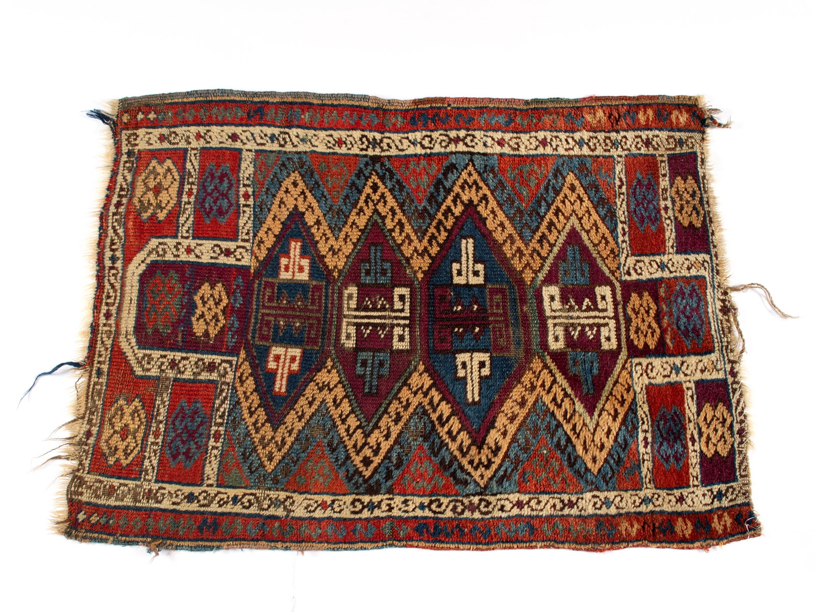 TURKISH THROW RUG: TURKISH THROW RUG Turkish, 19th century. Colorful geometric forms with latch hook outlining, running ivory border with red outer border. 3 ft. x 2 ft. (91.4 x 61 cm.)