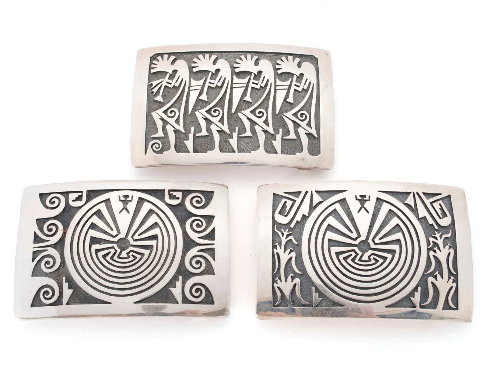 THREE HOPI STERLING SILVER BELT BUCKLES BY STEVEN SOCKYMA: THREE HOPI STERLING SILVER BELT BUCKLES BY STEVEN SOCKYMA 20th century, Hotevilla, Third Mesa of the Hopi Reservation, Arizona. Kokopelli flute-player belt buckle hallmarked to verso together with