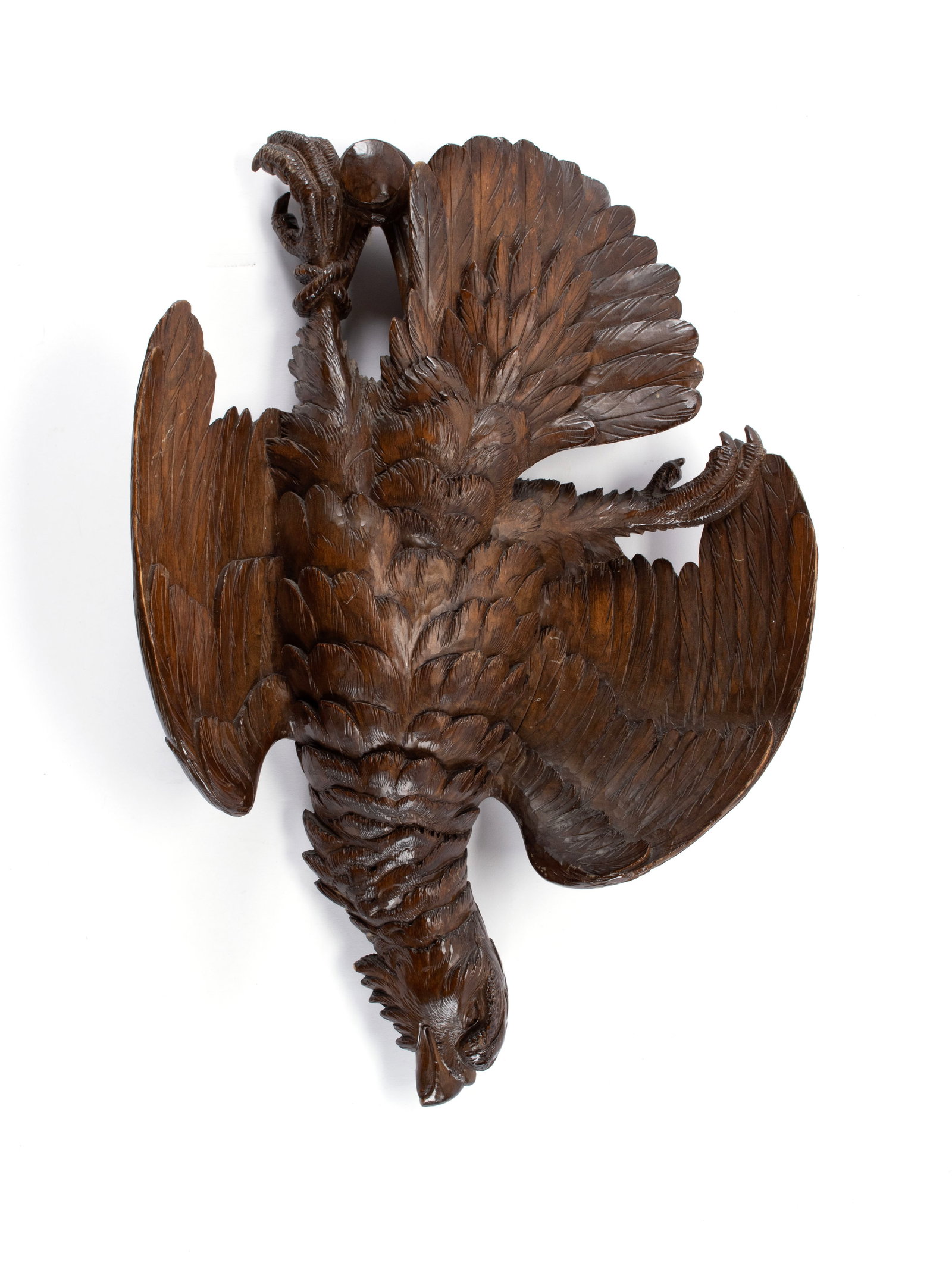 BLACK FOREST CARVED GAME BIRD: BLACK FOREST CARVED GAME BIRD German, 19th century. Hand-carved game bird with fine deep relief feather details. 22 x 15 in. (55.9 x 38.1 cm.)