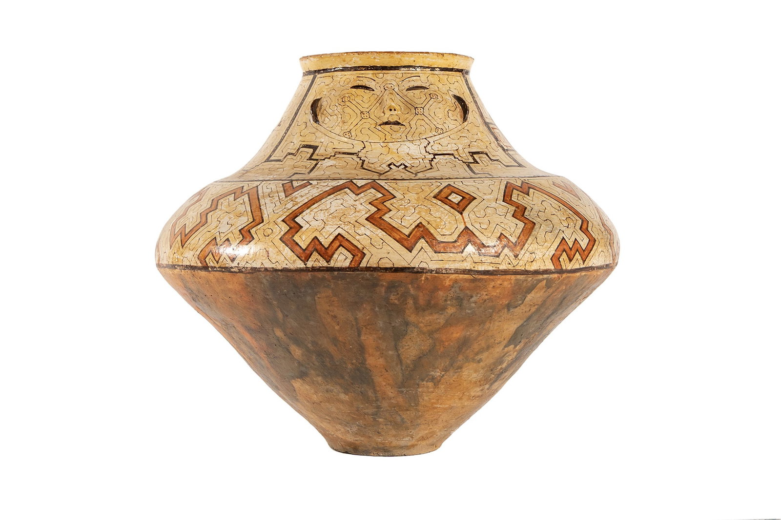 LARGE SHIPIBO POTTERY JAR: LARGE SHIPIBO POTTERY JAR South American, early 20th century. The jar formed with a facial medallion below the upper lip, polychrome decorated with red, brown, and creme geometric forms. 25 x 29 1/2