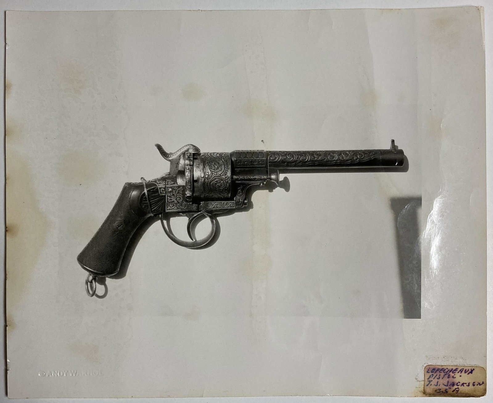 Andy WARHOL (USA, 1928-1987): Revolver Gun.photo print on albumen paper.Size: 8 1/10 by 10 in - 20,5 by 25,4 cm."C Andy Warhol" dry stamp with artist's estate stamp.Reference Warhol Foundation registration n Â° A08.430.Informati