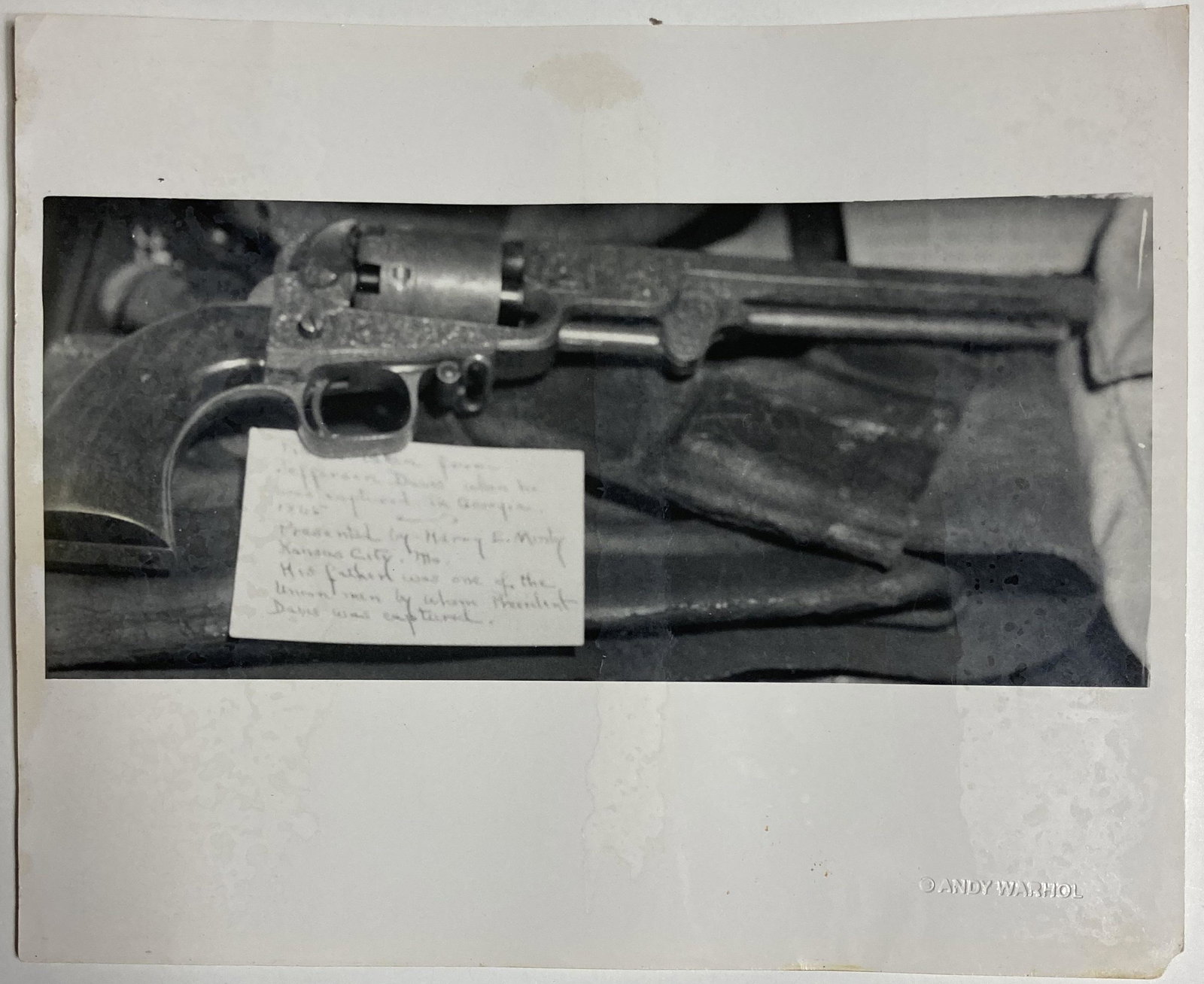 Andy WARHOL (USA, 1928-1987): Revolver Gun.photo print on albumen paper.Size: 8 1/10 by 10 in - 20,5 by 25,4 cm."C Andy Warhol" dry stamp with artist's estate stamp.Reference Warhol Foundation registration n Â° A08.426.Informati