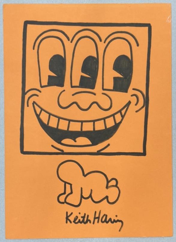 Keith HARING (USA, 1958-1990): Smiley with Three eyes - radiant baby, 1987.Black marker on orange paper.Signed bottom and center.size: 14 by 7 8/10 in - 35,5 by 19,8 cm.with the certificate of haring foundation.Provenance :- Berenb