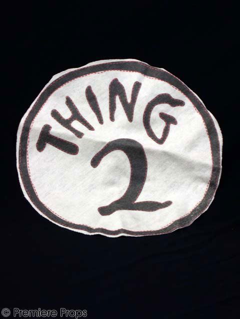 CAT IN THE HAT - Thing 2's Logo: CAT IN THE HAT - Thing 2's Costume Logo. A prototype logo for "Thing 2's" costume made during pre-production and written in imitation Dr. Seuss handwriting. This item measures 7" in diameter. Re-captu