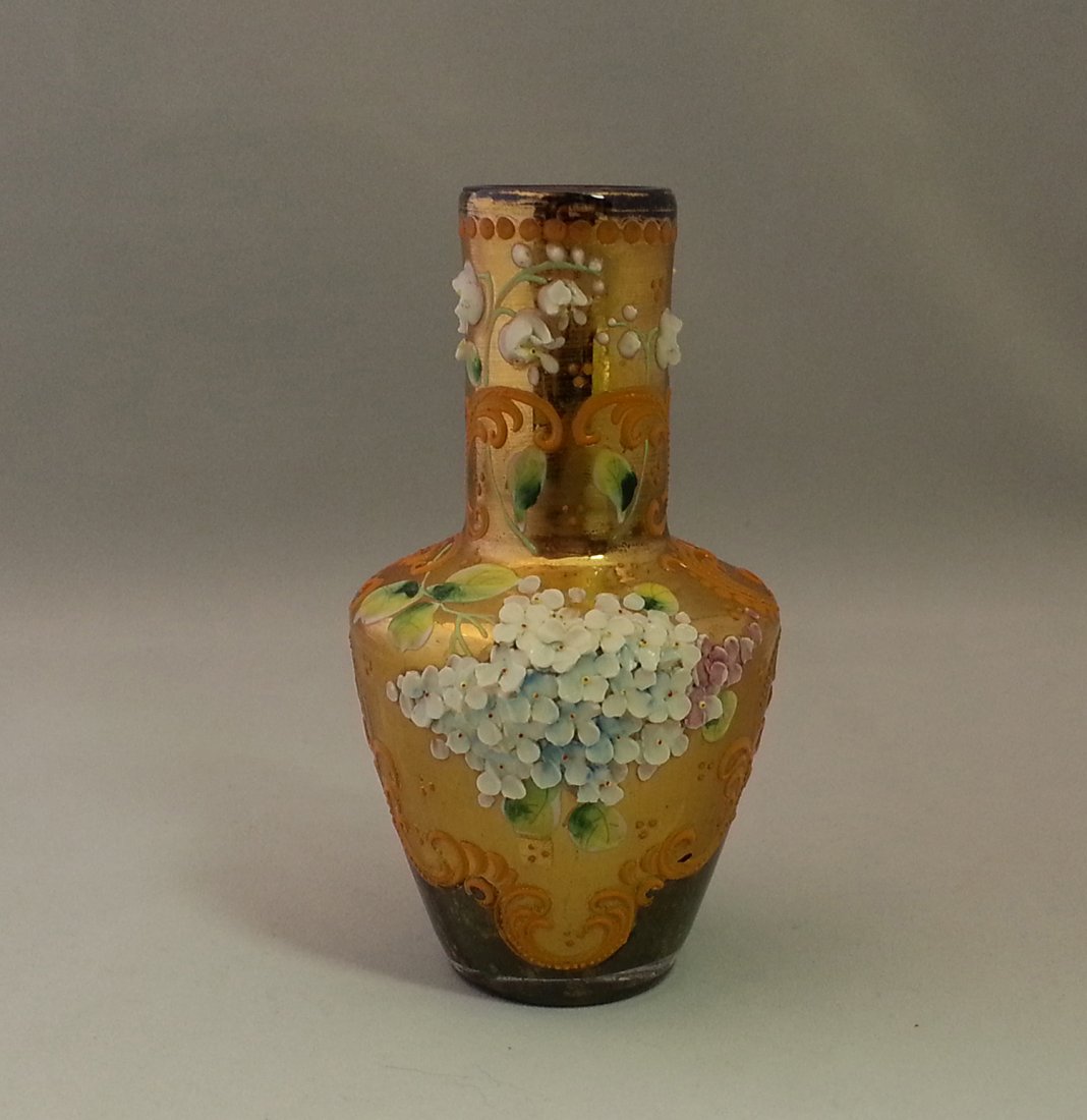 Moser Red Glass Aventurine Cabinet Vase Applied Flowers: Red aventurine cased glass cabinet vase. The vase is gilded over a large portion, then decorated with Rococo orange scrolls, polychrome enamel leaves, two bunches of applied high relief flowers, and a