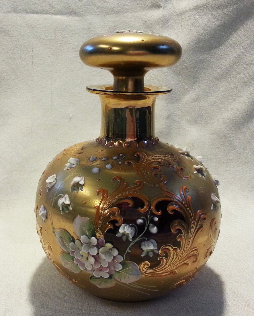 Moser Glass Cologne Bottle Perfume High Relief Flowers: Bohemian Glass cologne bottle with ruby stained / cranberry glass medallions surrounded by Rococo scrolls, two types of tiny applied high relief flowers, and hand painted polychrome enamel leaves. The
