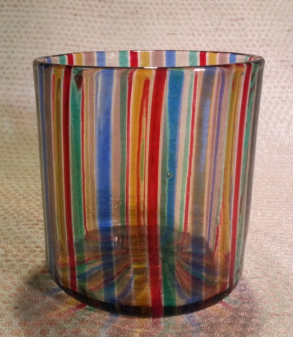 Gio Ponti A Canne Glass Tumbler Venini: Gio Ponti A Canne Glass Tumbler. Bright color canes. Venini Italy. Not signed. Paper label taped to bottom of tumbler. Size: 3" diameter; 3 1/8" high Condition: 2 minor scratches on side of glass - wo