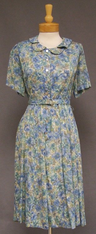 XL Blue & Green Floral Nylon 1950s 1960's Day Dress: A nice vintage day dress in a cream, aqua and blue floral nylon. Short sleeved bodice with faux mother of pearl buttons and double peter pan collar. Dress is semi-sheer so you will probably want to we