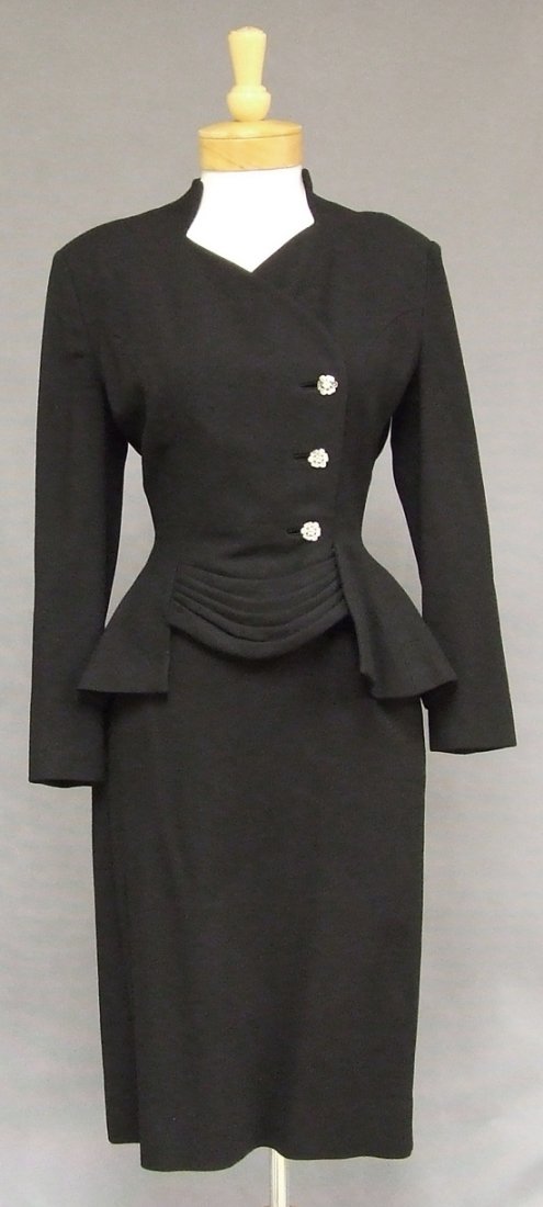 Iconic Lilli Ann Black Wool 1950s Suit w/ Rhinestones: A gorgeous vintage 1950s suit. Fitted, pleated jacket with wide rhinestone buttons. Matching fitted skirt with side metal zipper. Jacket is fully lined in silk crepe. Skirt is partially lined in aceta