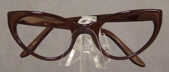 UNWORN Mocha 1950s 1960s Cateye Eyeglasses Frames: A classic pair of mocha colored authentic vintage optical frames. N/OS. Made in the USA by Harlequin. Size: Approximately 4 1/4" wide from hinge to hinge | 5 1/2" arm