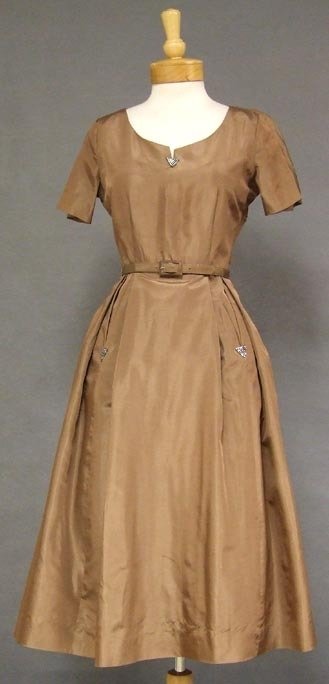 Ben Barrack Mocha Silk Taffeta 1950's Cocktail Dress 37: A beautiful 1950's cocktail dress in shimmering mocha silk taffeta. Short sleeved bodice with notched neckline. Appliqued triangle of rhinestones at the neckline and at the slit hip pockets on pleated