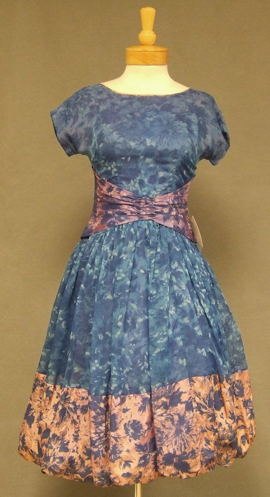 Blue Floral Chiffon 1950s 1960s Balloon Hemmed Dress: A charming vintage cocktail dress in blue floral acetate and nylon chiffon. Short sleeved bodice and full, balloon hemmed skirt (shown here with a crinoline... not included). Lined. Rear metal zipper.