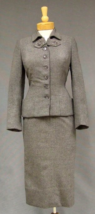 Ben Reig Grey Wool 1950s Suit w/ Beaded Trim: A stunning 1950s suit in grey wool. Fitted jacket with gorgeous beaded accent. Jacket is lined in silk taffeta. Matching straight skirt with faille lined waistband, side metal zipper and acetate linin