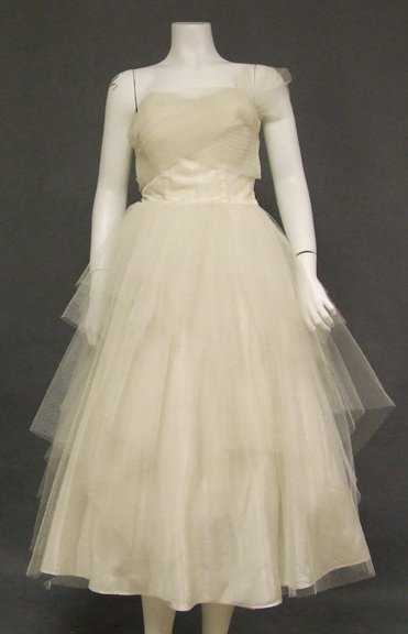 Ivory Tulle 1950s Prom Dress w/ Tiered Handkerchief Hem: A lovely 1950's dress that would make a great alternative wedding dress. Strapless bodice with finely pleated, wrapped bust and flounce at the left side. Dress has a full, tiered, handkerchief hemmed 