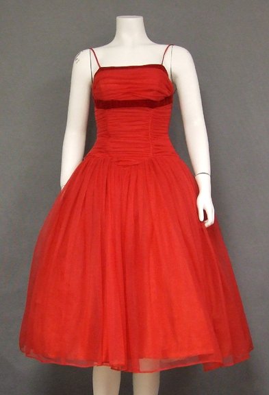 Red Chiffon Vintage 1950: A wonderful late 1950's cocktail dress in cherry red nylon chiffon. Fully, gathered, fitted, elongated bodice with velvet trim and spaghetti straps. dress has a lovely, floating skirt (shown here with