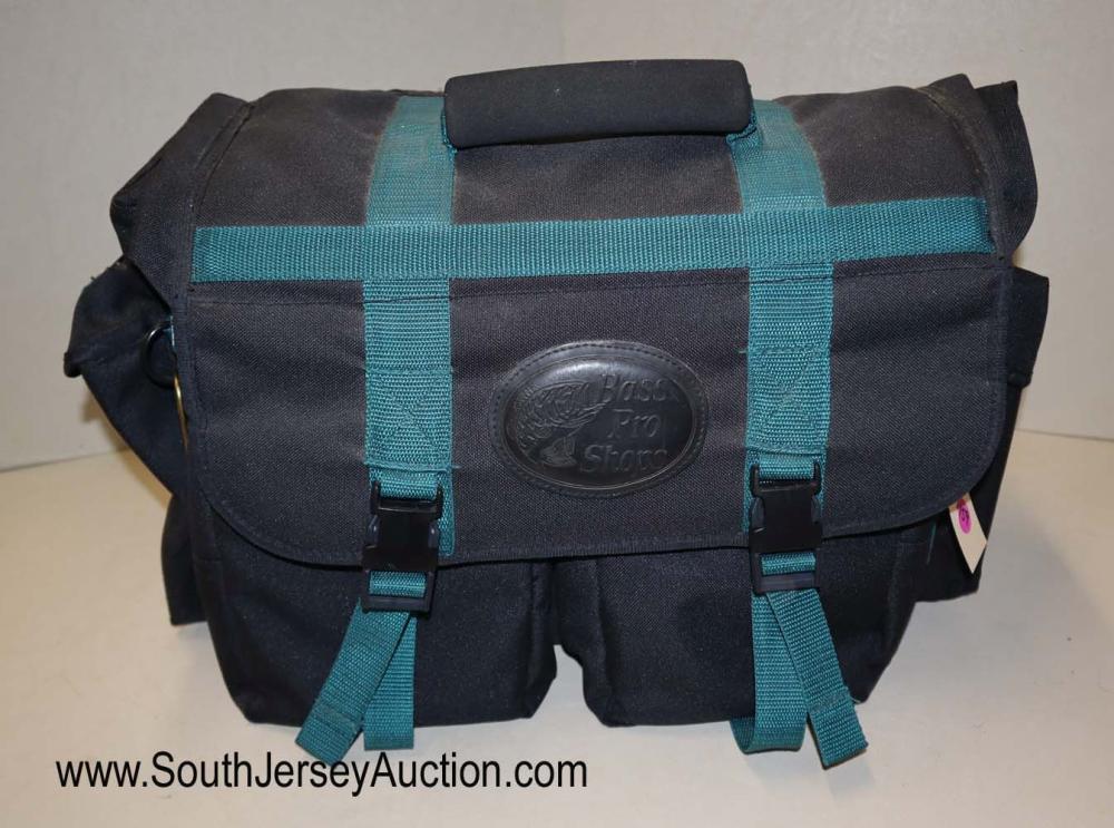 Fly fishing Bass Pro Shop tackle box with compass on it: Fly fishing Bass Pro Shop tackle box with compass on it with assorted fly's, sun glasses, weights, paperwork and more Dimensions: 21" l x 11" w x 12" d