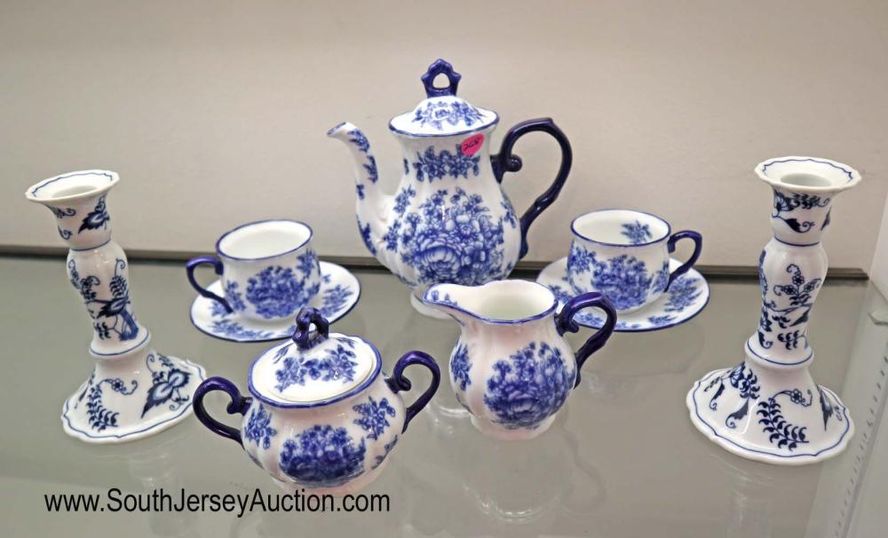 9 piece lot (7) blue and white Ironstone tea set - (2): 9 piece lot (7) blue and white Ironstone tea set - (2) candle sticks by Blue Danube Dimensions: tea pot 8" h x 7" w creamer 4" h x 4" w sugar 4" h x 4" w cups and saucers 3" h x 5 1/2" diameter candle