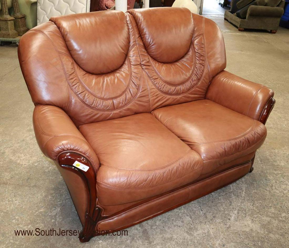 Double stitched mahogany arm leather loveseat: Double stitched mahogany arm leather loveseat - no tears no rips Dimensions: 58" w x 40" d x 40" h