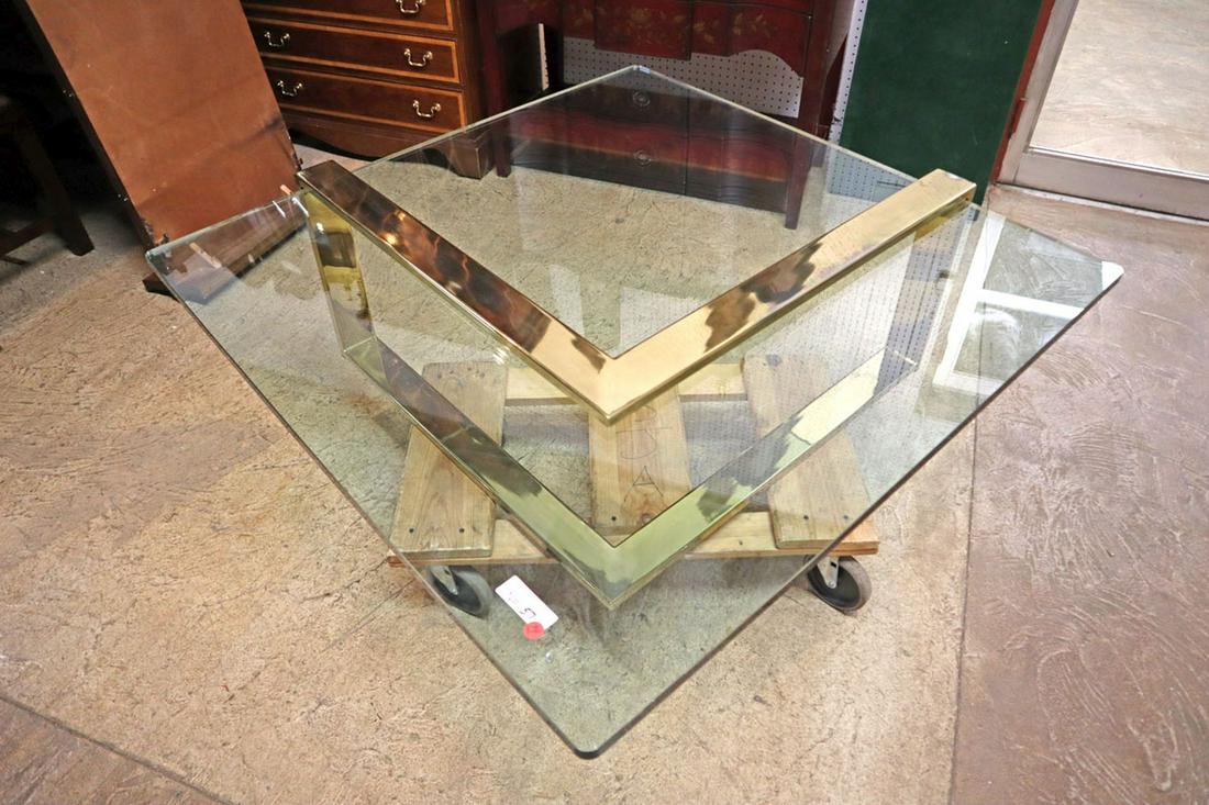 MCM brass/glass table, manner of Milo Bowman: Mid Century Modern brass and glass cocktail / coffee table in the manner of Milo Bowman in good condition approx. 42" w x 42" d x 16" h